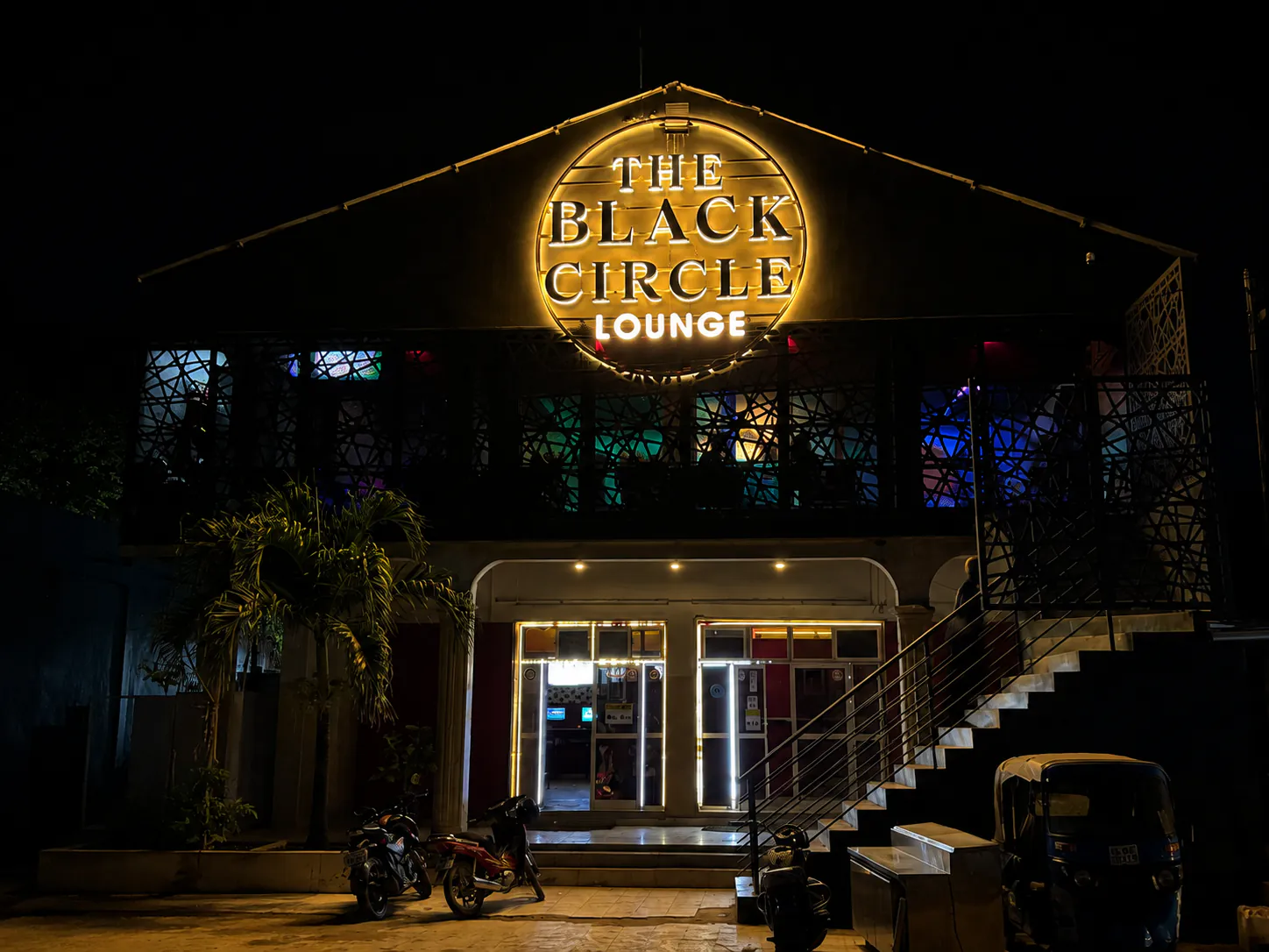 Black Circle Lounge exterior at night with illuminated sign.